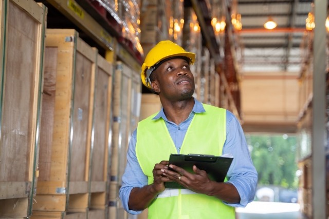 A man checks inventory in a warehouse