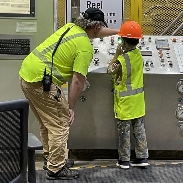 Cedar River, Iowa Boy Scout helps to push a button in a facility